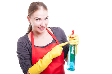 Pretty smiling housekeeper with cleaning spray