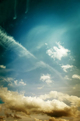 Fototapeta premium Fog and clouds looking up into a fantasy evening sky. Image looks antique, In orange and green colors