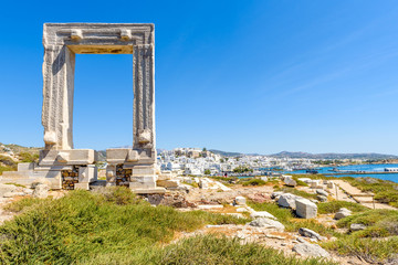 The Portara, one of Naxos most famous landmarks connected to Naxos (Chora) town by a causeway. Cyclades Islands, Greece. 