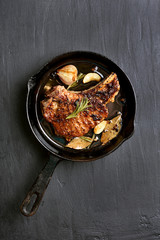 Grilled pork steak in frying pan