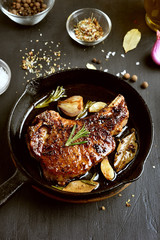 Fried pork steak in frying pan