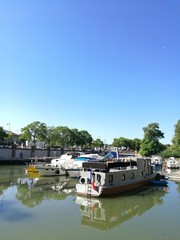 Fototapeta na wymiar MULHOUSE, FRANCE - JUNE 17, 2017 : leisure boats parked in Mulhouse harbor during summer along the Rheine river.