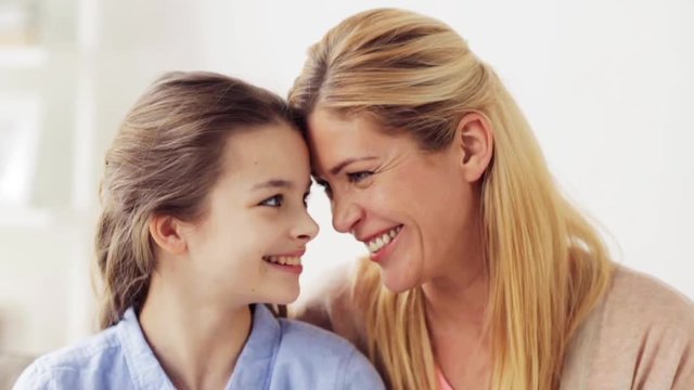 happy mother and girl looking at each other