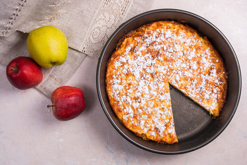 Apple pie with fresh fruits on light marble background