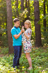 Fototapeta premium Happy young pregnant couple hugging in nature