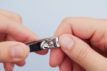 Woman cutting her fingernails with nail clipper
