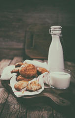 Cookies with a glass of Milk.  Homemade Cakes on Wooden Vintage Background.Toned image.Vintage style.Copy space for Text. selective focus.