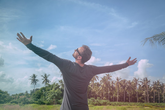 Man with arms wide open enjoying in nature.