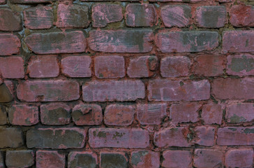 Obraz premium The old brick and stone wall with plaster