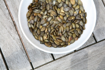 pumpkin seeds in white porcelain bowl