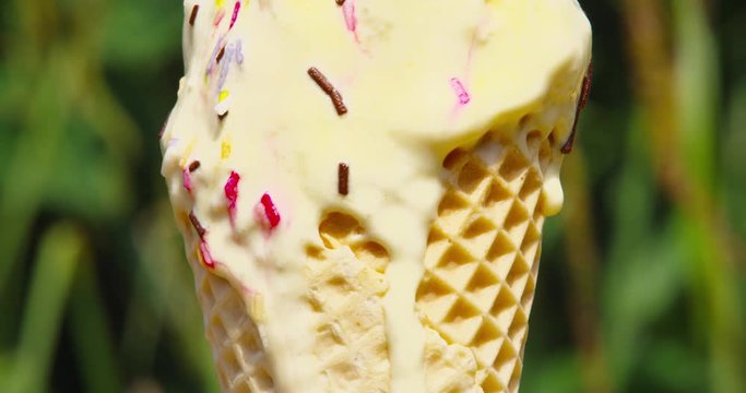 Time lapse of melting vanilla ice cream with sprinkles on a summers day