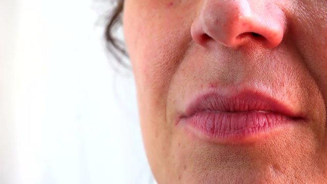 graded shots of closeup of eyes,  lips and smile of mature Caucasian woman with Arabic and Middle Eastern somatic traits with very soft skin