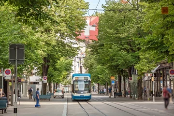 Foto auf Acrylglas Zurich shopping street Bahnhofstrasse with tram and swiss flag © aldorado