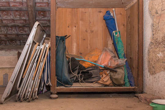 Old, dirty and grunge camping equipment stored in an attic of old country house.