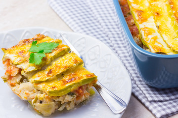 Portion of zucchini casserole on a plate.  Healthy nutrition.