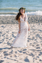 Fototapeta na wymiar Beautiful girl on the beach in a beautiful dress. Sunny day, white sand, boho