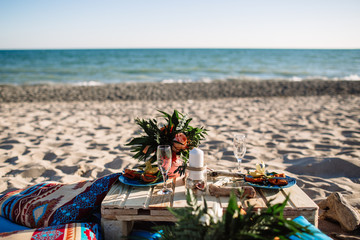 Romantic dinner, candles at ocean beach. Honeymoon, proposal or wedding background concept
