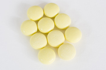 Fototapeta na wymiar Pharmacy theme, yellow medicine tablets isolated on white background