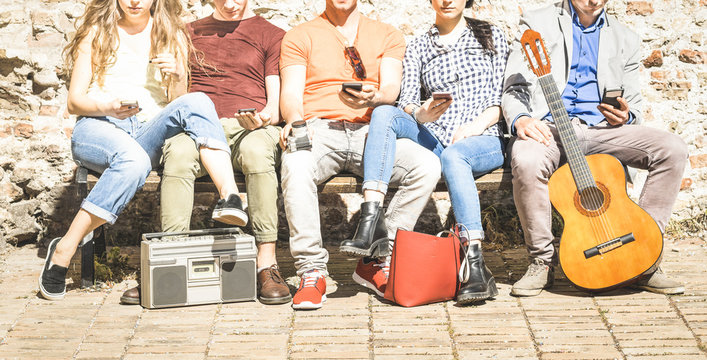 Group of multicultural friends using smartphone on urban background - Technology addiction concept in youth lifestyle disinterested to each other - Always connected people on modern mobile smart phone