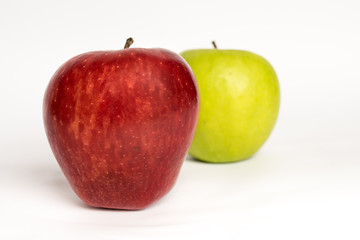 Two apples together a red and a green (isolated). Isolated apples on a clear background. Representation of the difference. Different concept.