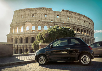 Fototapeta na wymiar Retro car parking near the Coliseum - one of famous and very pop