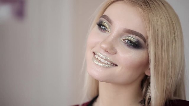 Makeup artist makes a girl beautiful makeup before an important event