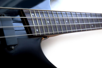 Black bass guitar with a fretboard.