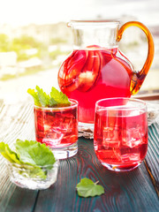 Berry compote decanter glasses with apple slices on wooden rustic background solar.