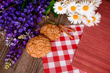 Close up on traditional bread on the table, next to flowers daisies and lupins