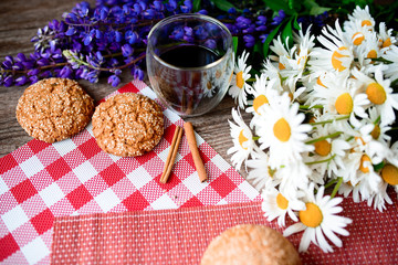 Close up on traditional bread on the table, next to flowers daisies and lupins