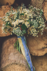 Beautiful wedding bouquet between wood