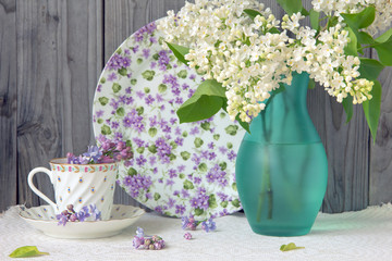 Bouquet of a white lilac on a wooden background.