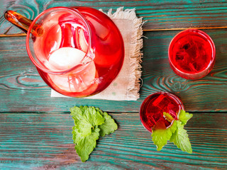 Berry compote decanter glasses with apple slices on wooden rustic background solar.