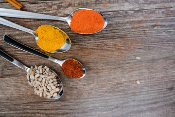 Various spices spoons on stone table. Top view with copy space