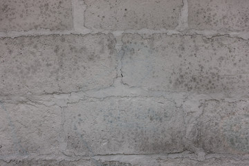 The old brick and stone wall with plaster