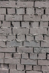 The old brick and stone wall with plaster