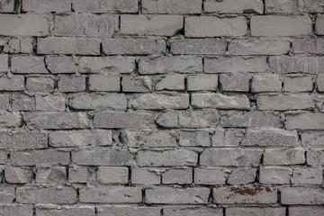 The old brick and stone wall with plaster