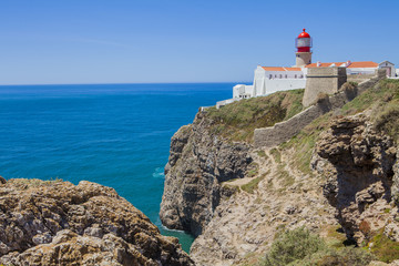 Fototapeta na wymiar Lighthouse at Cabo de Sao Vicente, Algarve, Portugal. The lighthouse is situated on the tip of the Cape of St. Vincent, the extreme southwesternmost point in Europe 