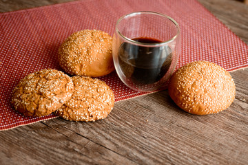 Fresh bread, cookies and coffee on wooden table.