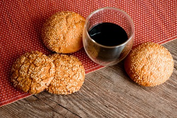 Fresh bread, cookies and coffee on wooden table.