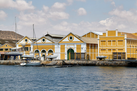 The military area with yellow buildings, in which the entrance is closed. Located in an open area near the port. Cartagena, Spain.