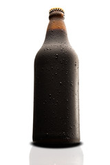 Brown wet Bottle of black beer isolated on white background
