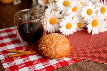 bread and coffee,flowers on the table in the morning