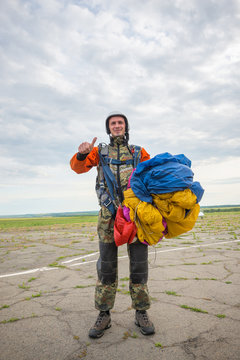 Happy Skydiver Is Standing On The Airfield