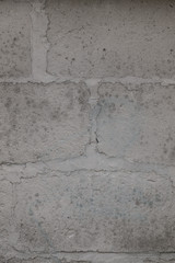 The old brick and stone wall with plaster
