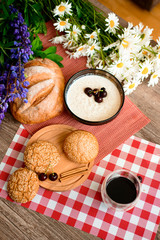 coffee,oatmeal,Fresh bread and chamomile flowers and lupins on the garden table. On the morning of the background.