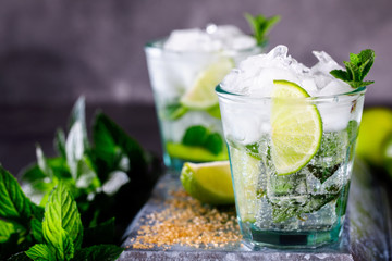 Mojito Cocktail.Mint, lime, ice ingredients for making  and bar utensils.Cold Drink.Top View.Copy space for Text.selective focus. - obrazy, fototapety, plakaty
