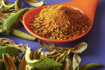 close up of indian achar masala with dry mango  slice inm a spoon