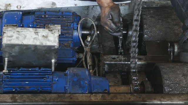 4k of Hand of repairman during maintenance work of chain