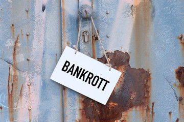 Eine alte rostige Tür und ein Schild mit dem Aufdruck Bankrott